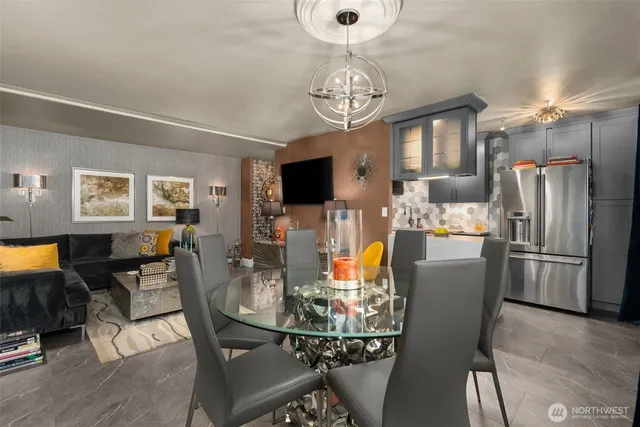 a view of a dining room with furniture and a chandelier