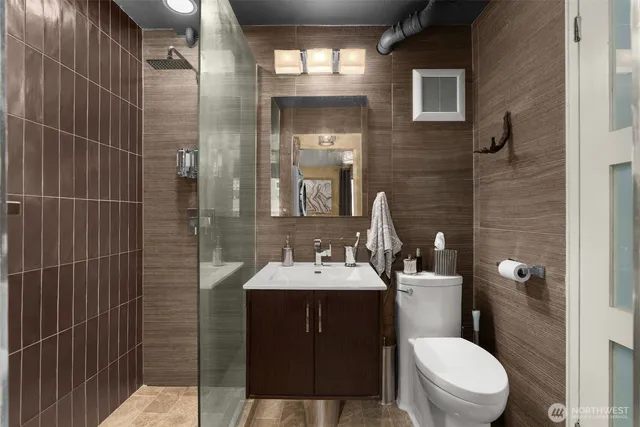 a bathroom with a sink toilet and shower