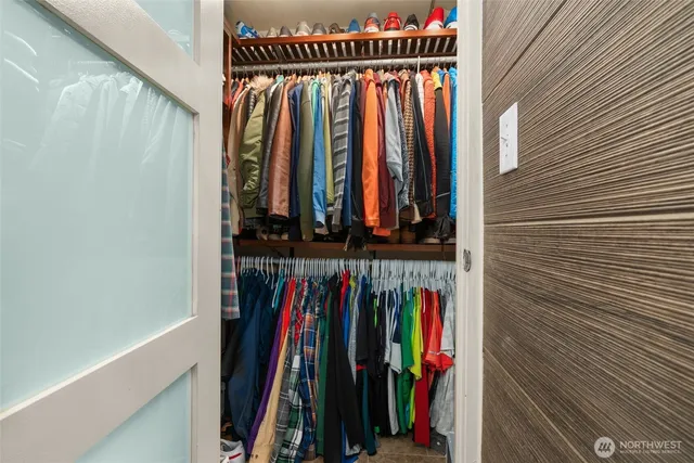 a view of walk in closet with clothes