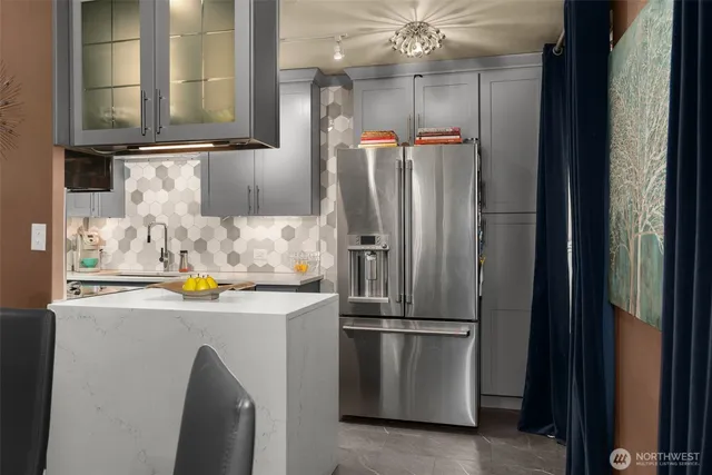 a kitchen with stainless steel appliances granite countertop a refrigerator and a sink