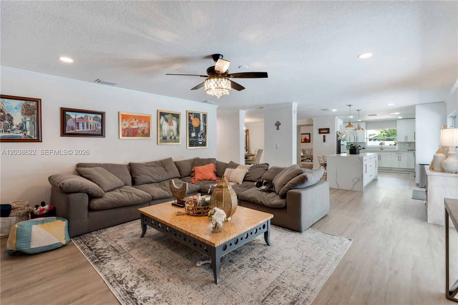 14830 Southwest 149th Street Miami, FL 33196 - Photo 12 of 43 a living room with furniture a rug and a chandelier