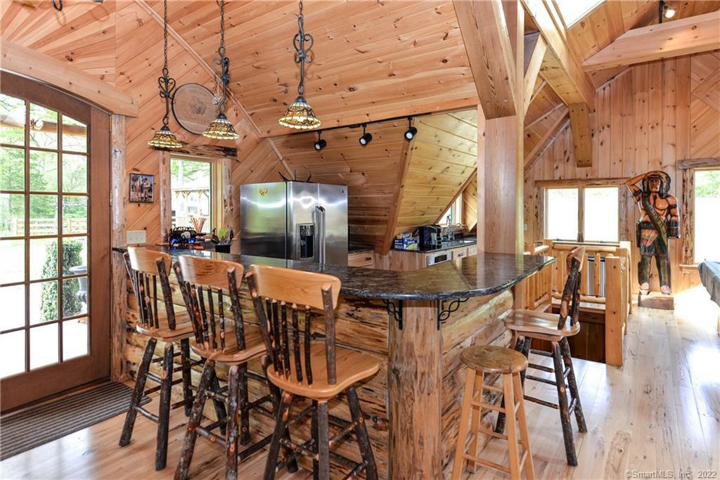555 West Purchase Road Southbury, CT 06488 - Photo 3 of 15 a dining room with furniture a chandelier and wooden floor
