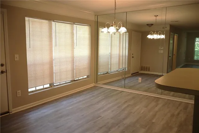 a view of a room with wooden floor and windows