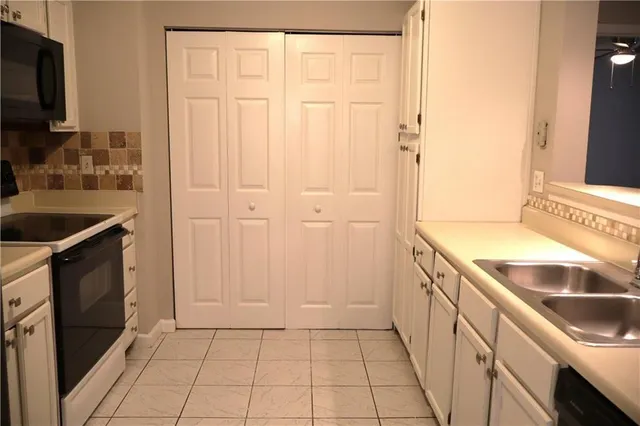 a kitchen with a sink and a refrigerator
