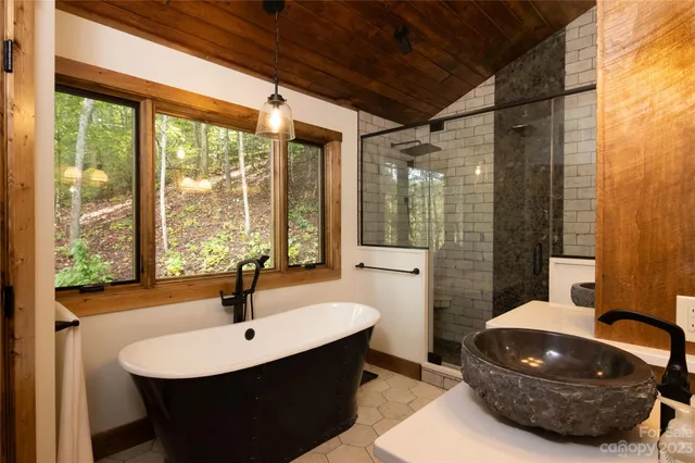 a bathroom with a sink mirror and window