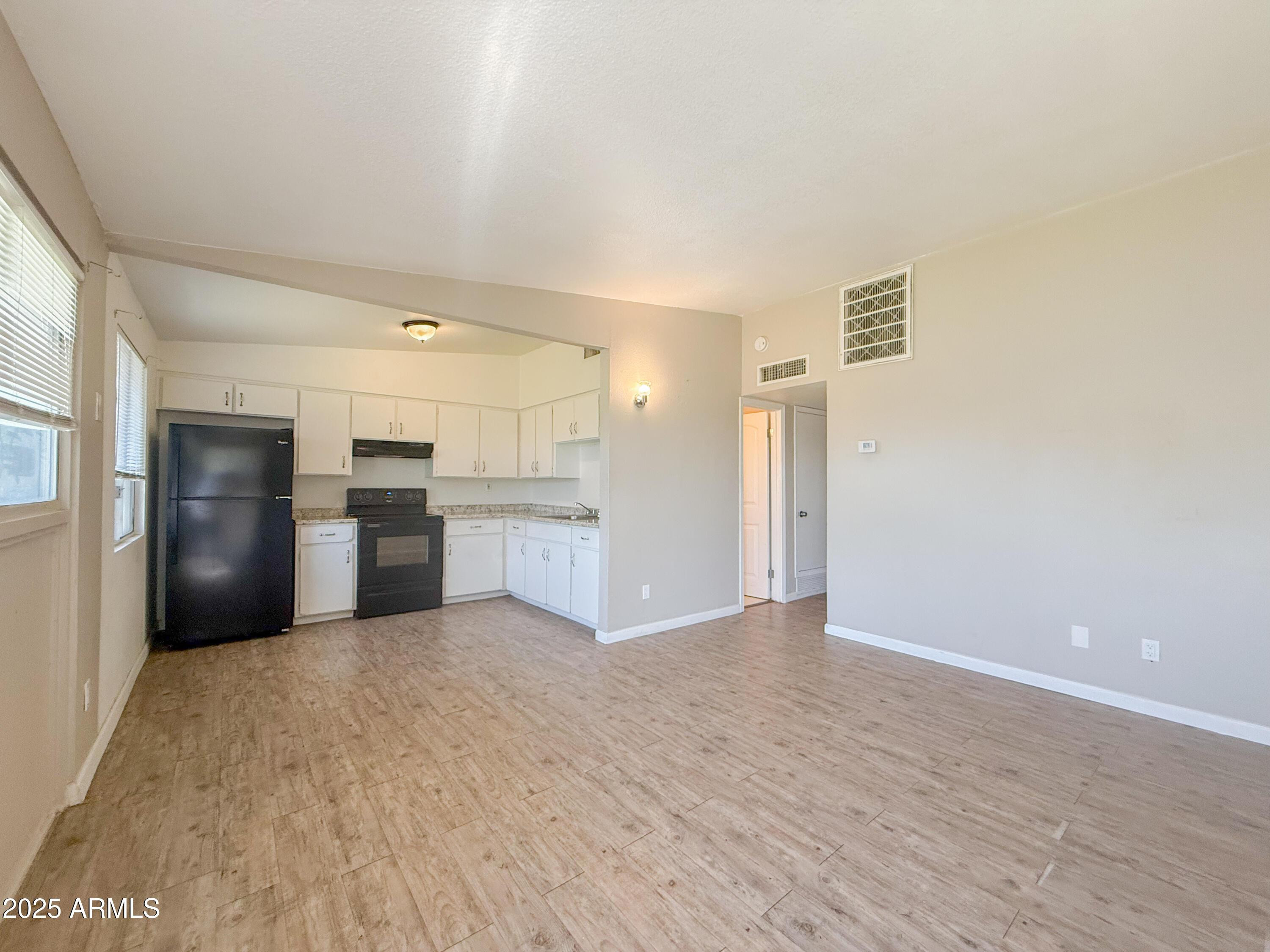 2123 West Devonshire Avenue, Unit 15 Phoenix, AZ 85015 - Photo 4 of 14 a view of a kitchen with a sink and a refrigerator