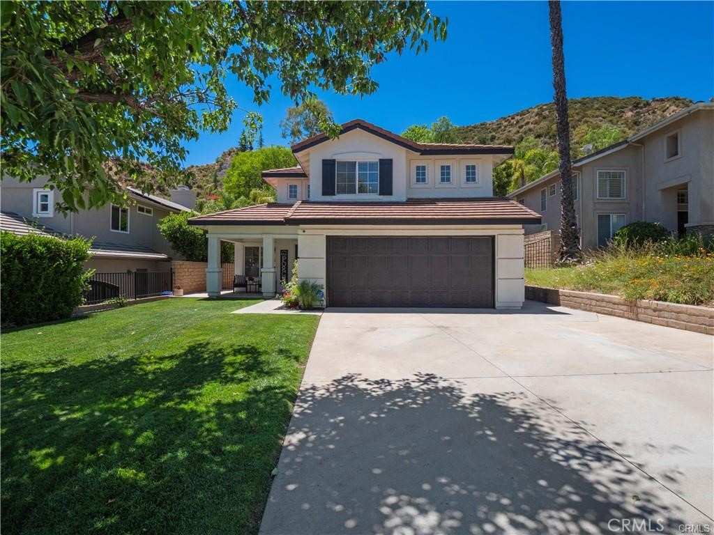 28204 Cascade Road Castaic, CA 91384 - Photo 1 of 1 a front view of a house with a yard and garage