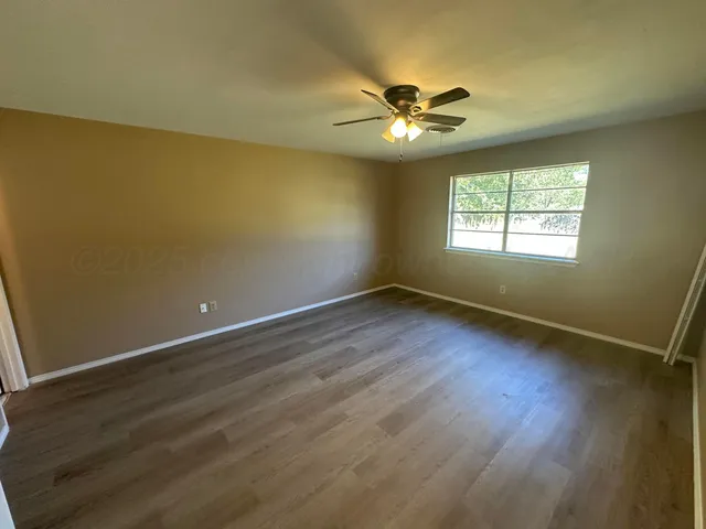 wooden floor in an empty room with a fireplace