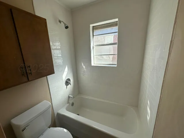 a white toilet sitting next to a sink