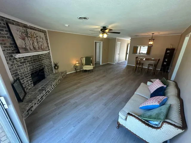 a living room with furniture and wooden floor