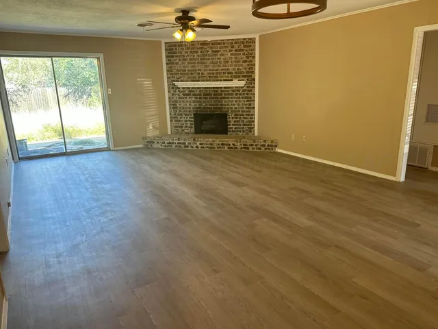 an empty room with a fireplace and window