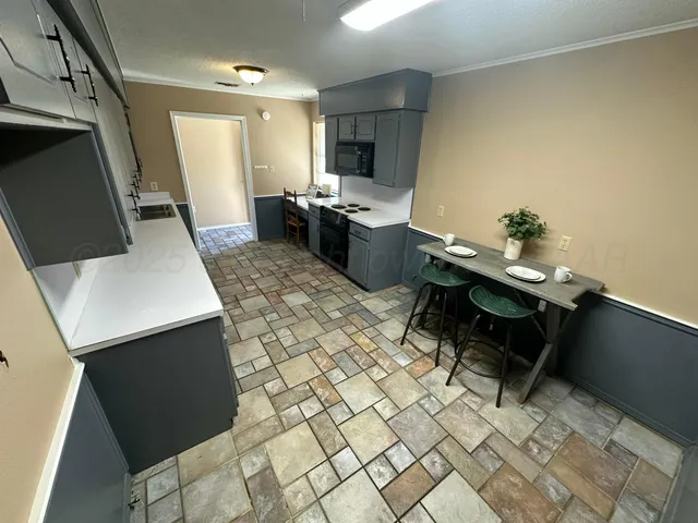a kitchen with a sink and a refrigerator
