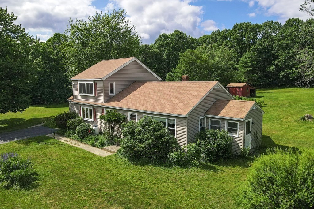 89 Whitney Road Ashby, MA 01431 - Photo 1 of 30 a front view of a house with a yard