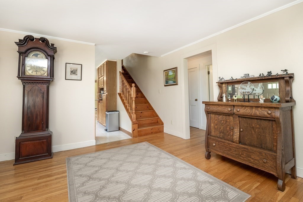 89 Whitney Road Ashby, MA 01431 - Photo 11 of 30 a view of a hallway with entryway wooden floor and cabinet