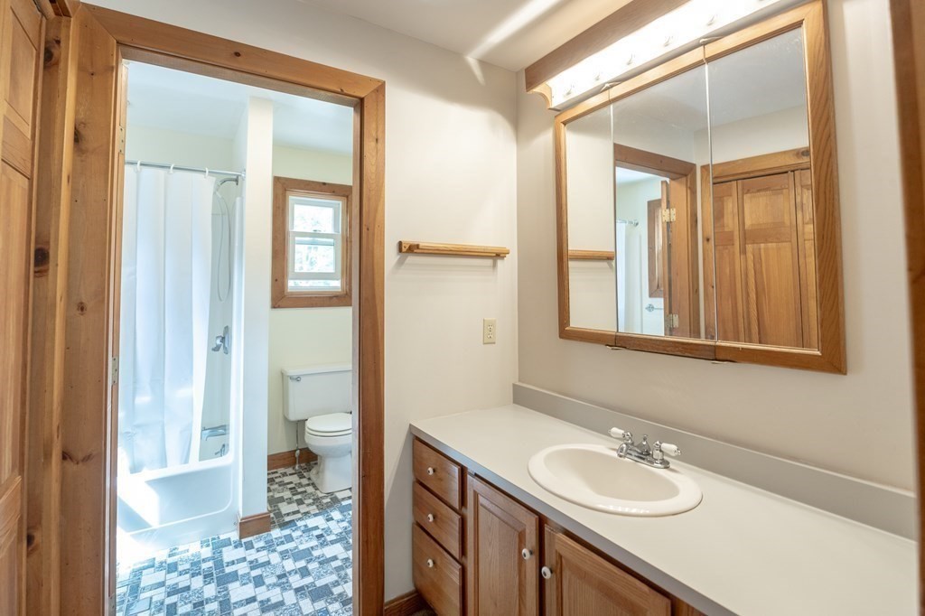 89 Whitney Road Ashby, MA 01431 - Photo 19 of 30 a bathroom with a sink a toilet and a mirror