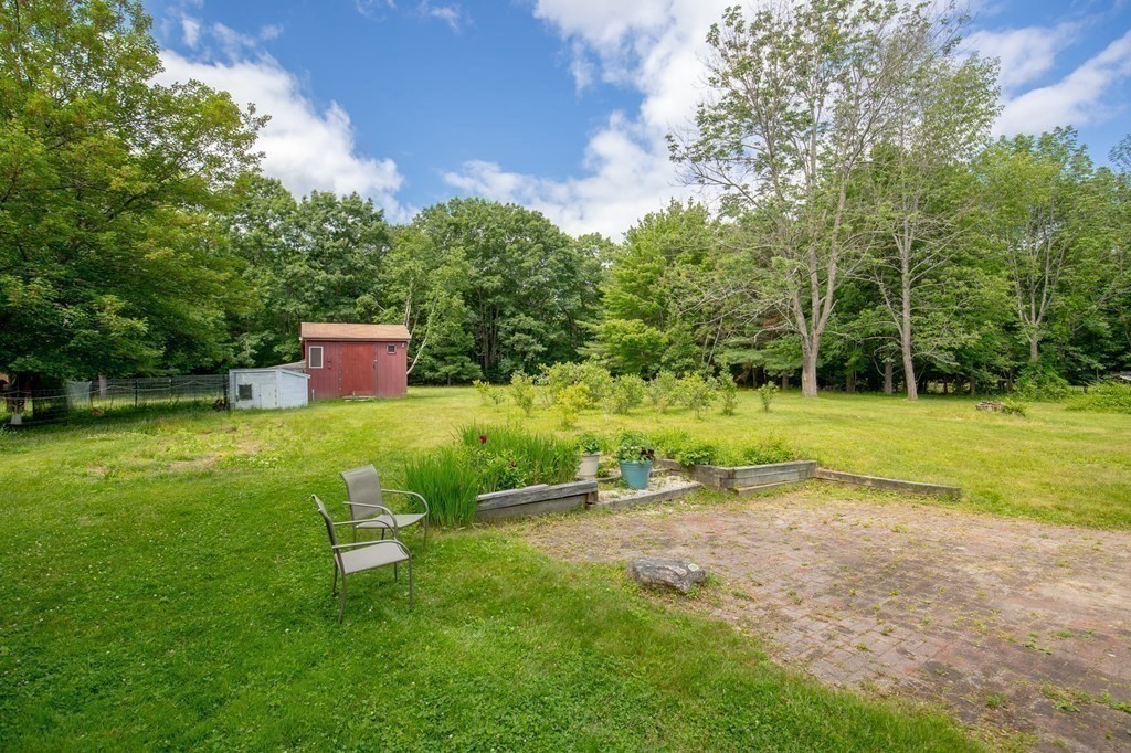 89 Whitney Road Ashby, MA 01431 - Photo 23 of 30 a backyard of a house with table and chairs