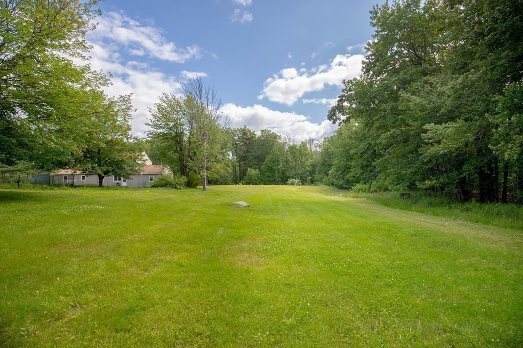 89 Whitney Road Ashby, MA 01431 - Photo 25 of 30 a view of a green field with wooden fence