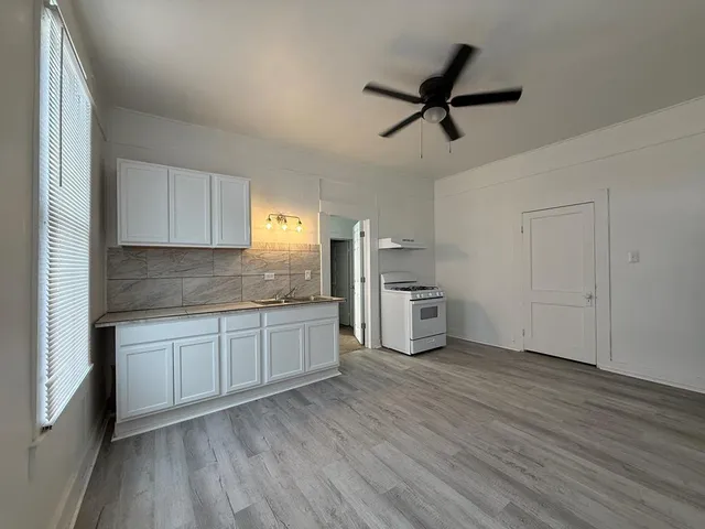 a kitchen with a refrigerator and cabinets