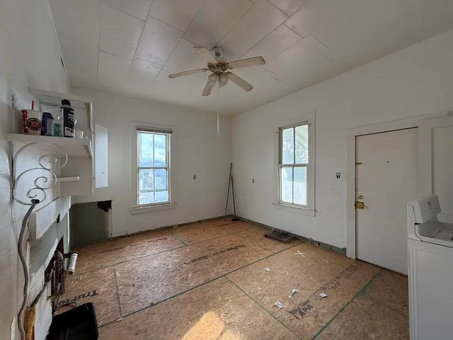 an empty room with windows and closet