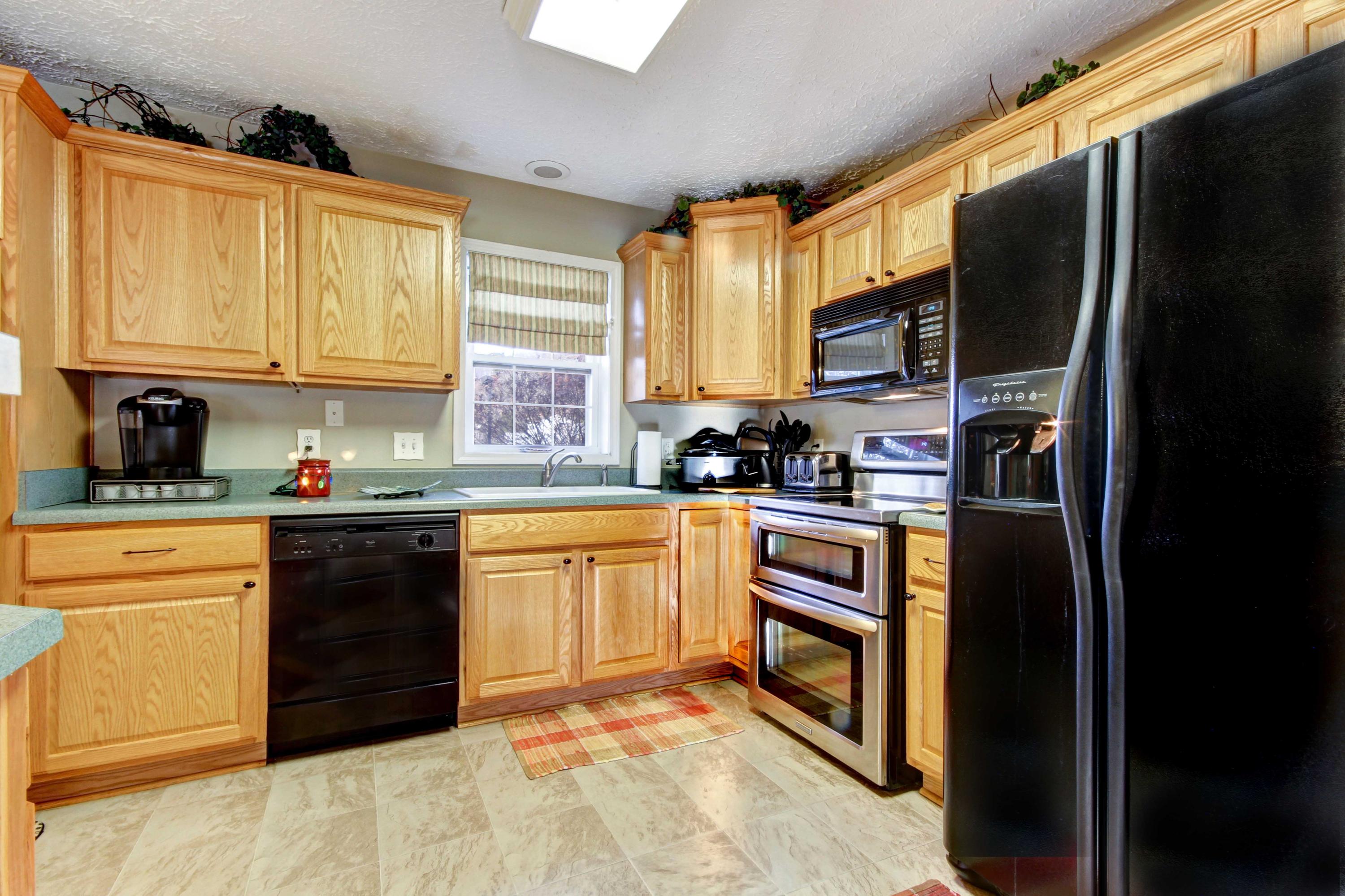 4690 Crosier Road Elliston, VA 24087 - Photo 23 of 79 a kitchen with stainless steel appliances granite countertop a refrigerator a stove a sink dishwasher and wooden cabinets