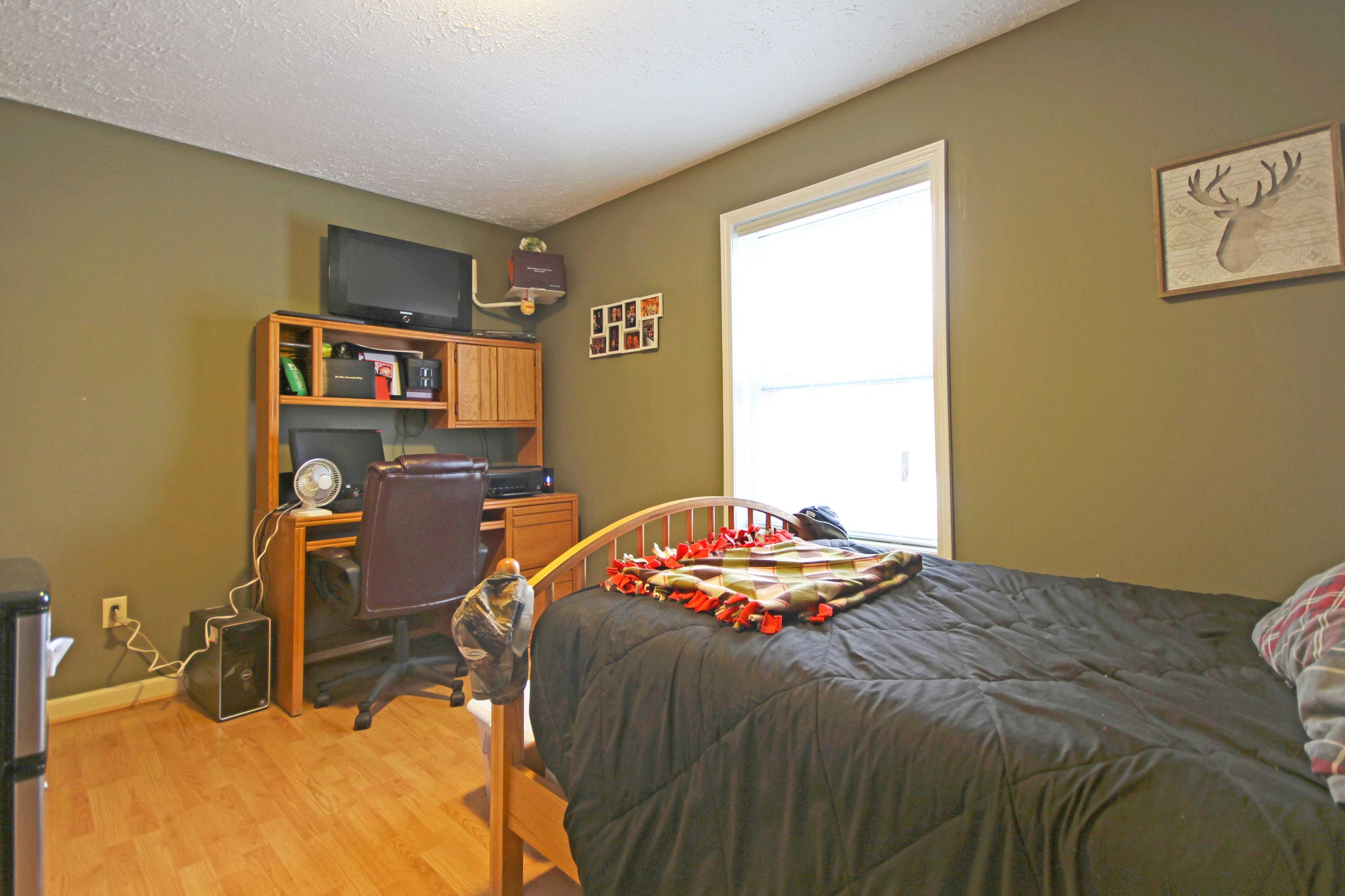 4690 Crosier Road Elliston, VA 24087 - Photo 29 of 79 a bedroom with a bed and a table in it