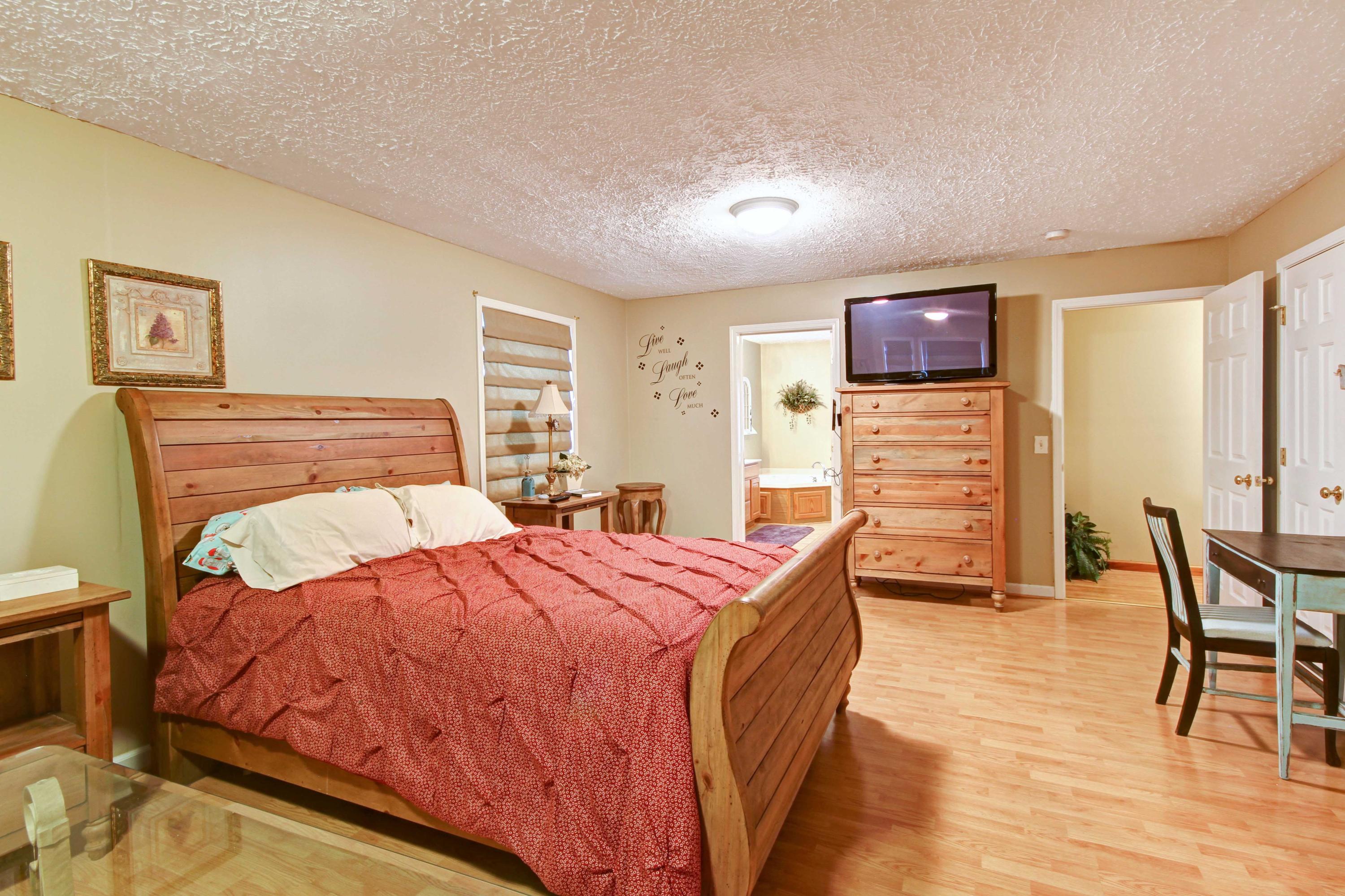 4690 Crosier Road Elliston, VA 24087 - Photo 32 of 79 a bedroom with a bed and wooden floor