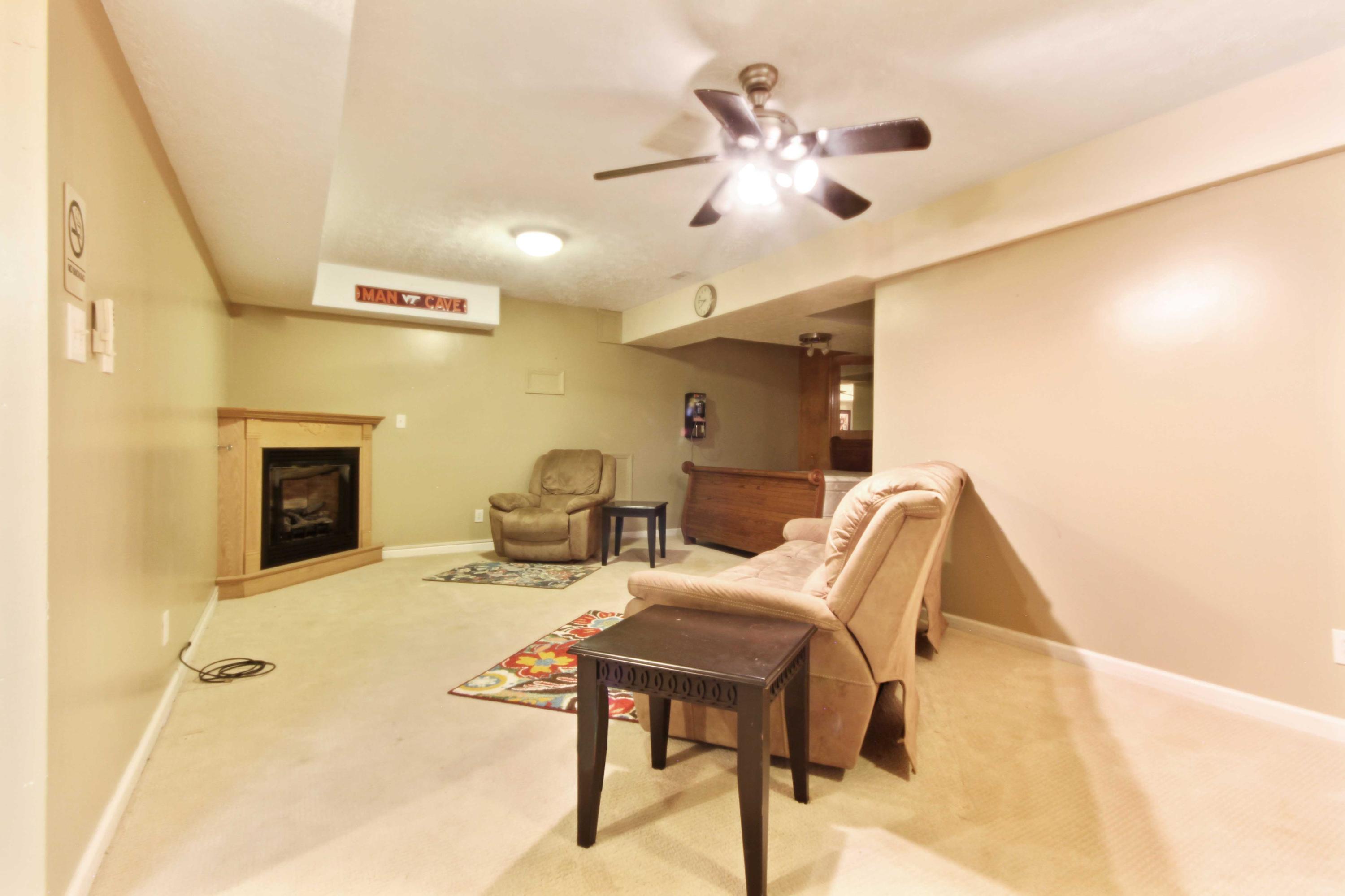 4690 Crosier Road Elliston, VA 24087 - Photo 48 of 79 a living room with furniture and a fireplace