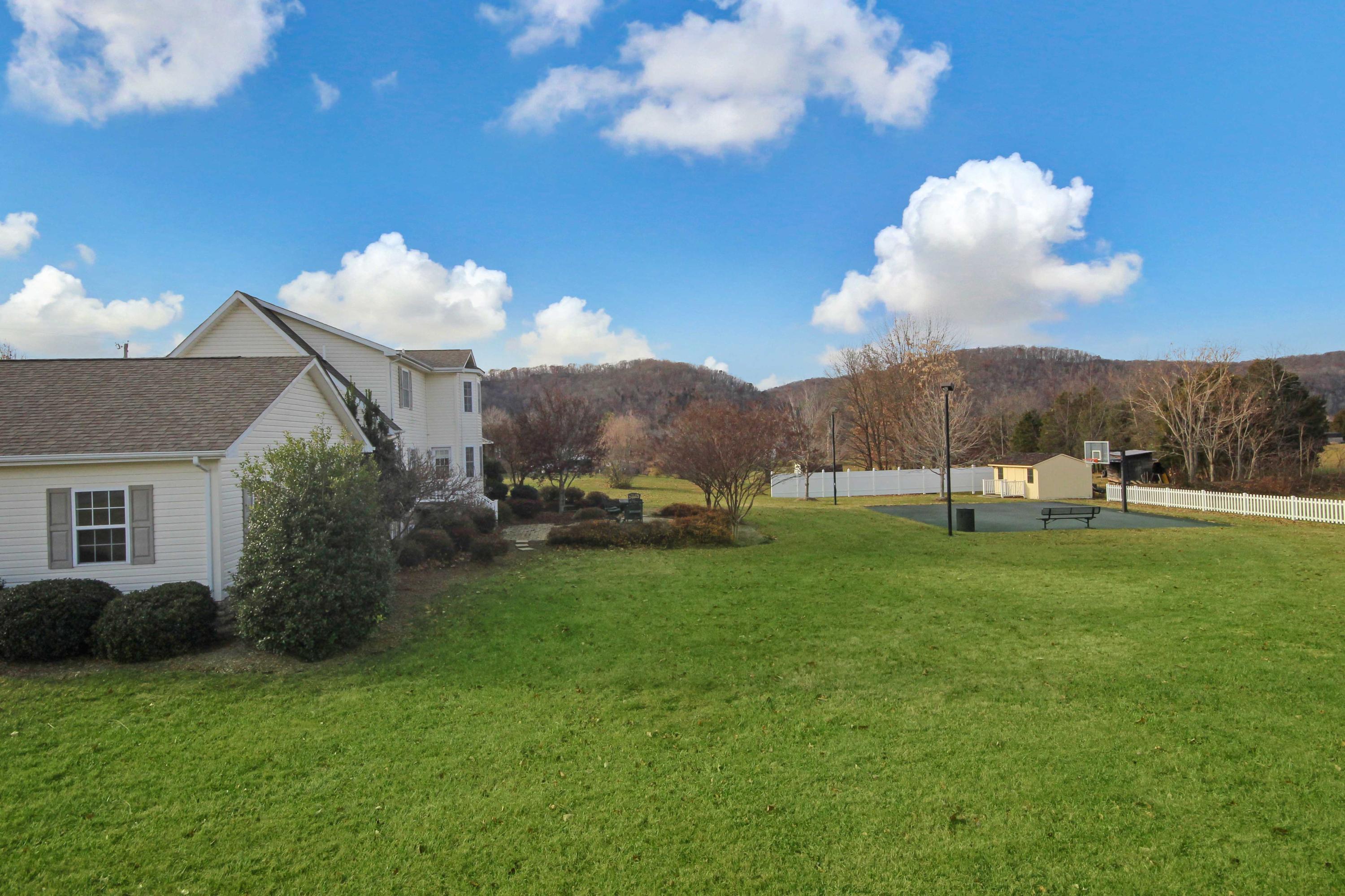 4690 Crosier Road Elliston, VA 24087 - Photo 70 of 79 a view of a white house in a big yard with large trees