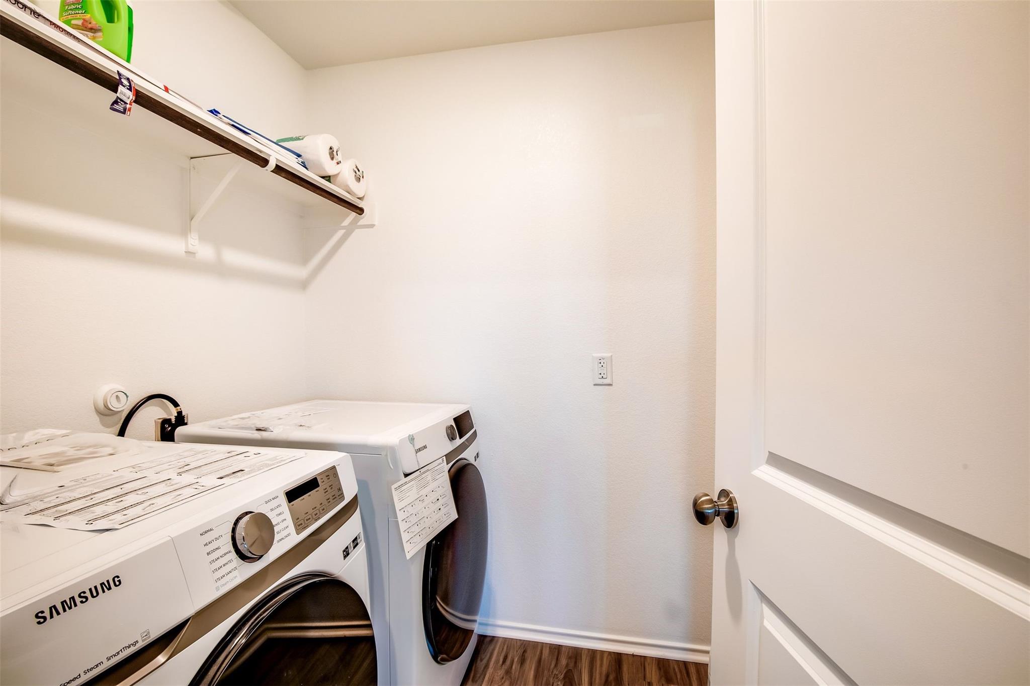 614 Milliner Loop Hutto, TX 78634 - Photo 6 of 25 Functional laundry nook provides practical space for household chores, complete with durable flooring.