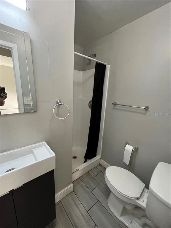 2795 L B McLeod Road, Unit C Orlando, FL 32805 - Photo 5 of 5 a white toilet sitting next to a bathroom sink