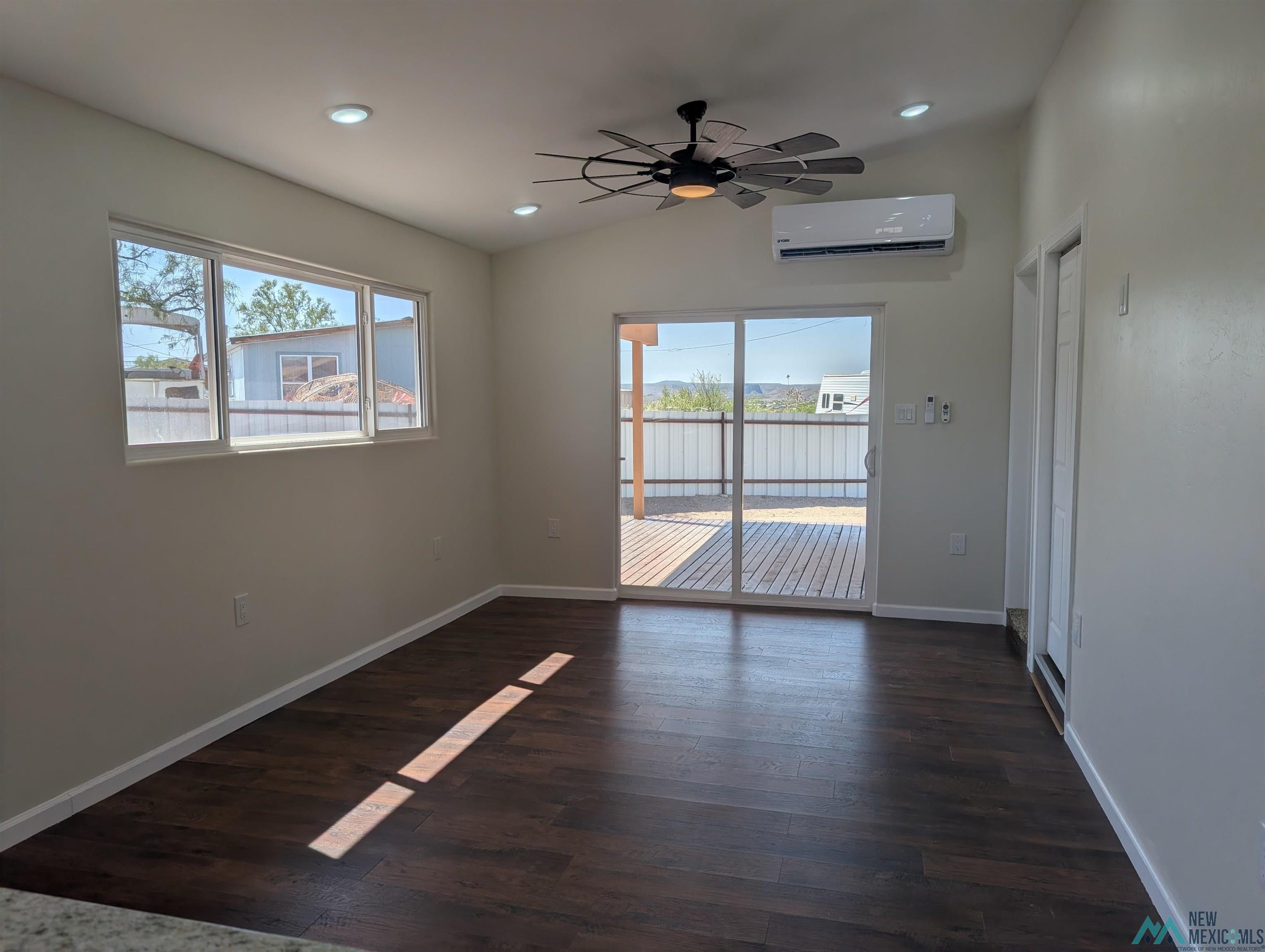 506 Bass Road Elephant Butte, NM 87935 - Photo 9 of 23 Open concept living area featuring dark wood-finish flooring, vaulted ceilings, and recessed lighting