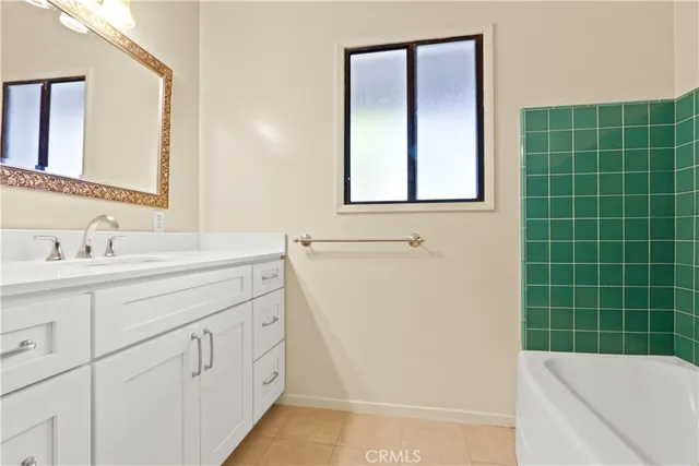 a bathroom with a sink a vanity and a mirror