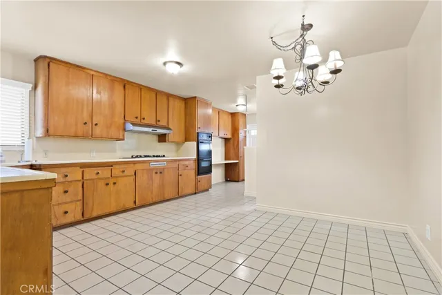 a kitchen with a sink cabinets and window