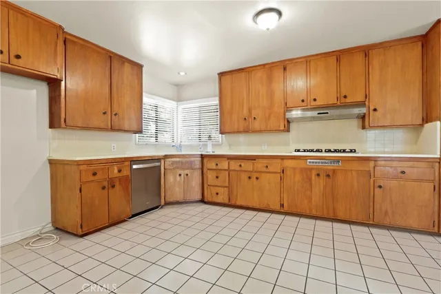 a kitchen with a sink window and cabinets