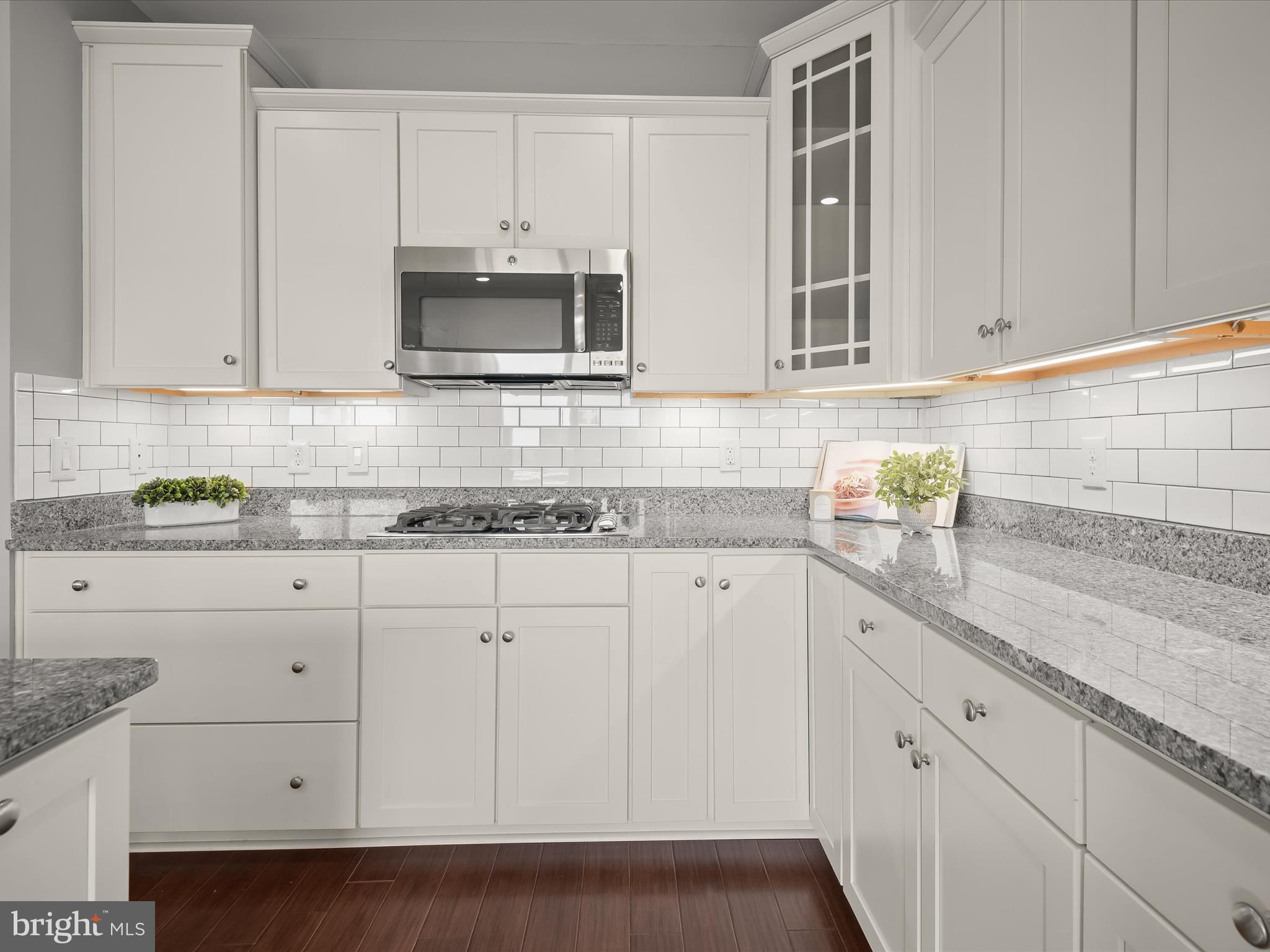 179 Copley Circle, Unit 30B Gaithersburg, MD 20878 - Photo 15 of 41 a kitchen with granite countertop white cabinets and a sink