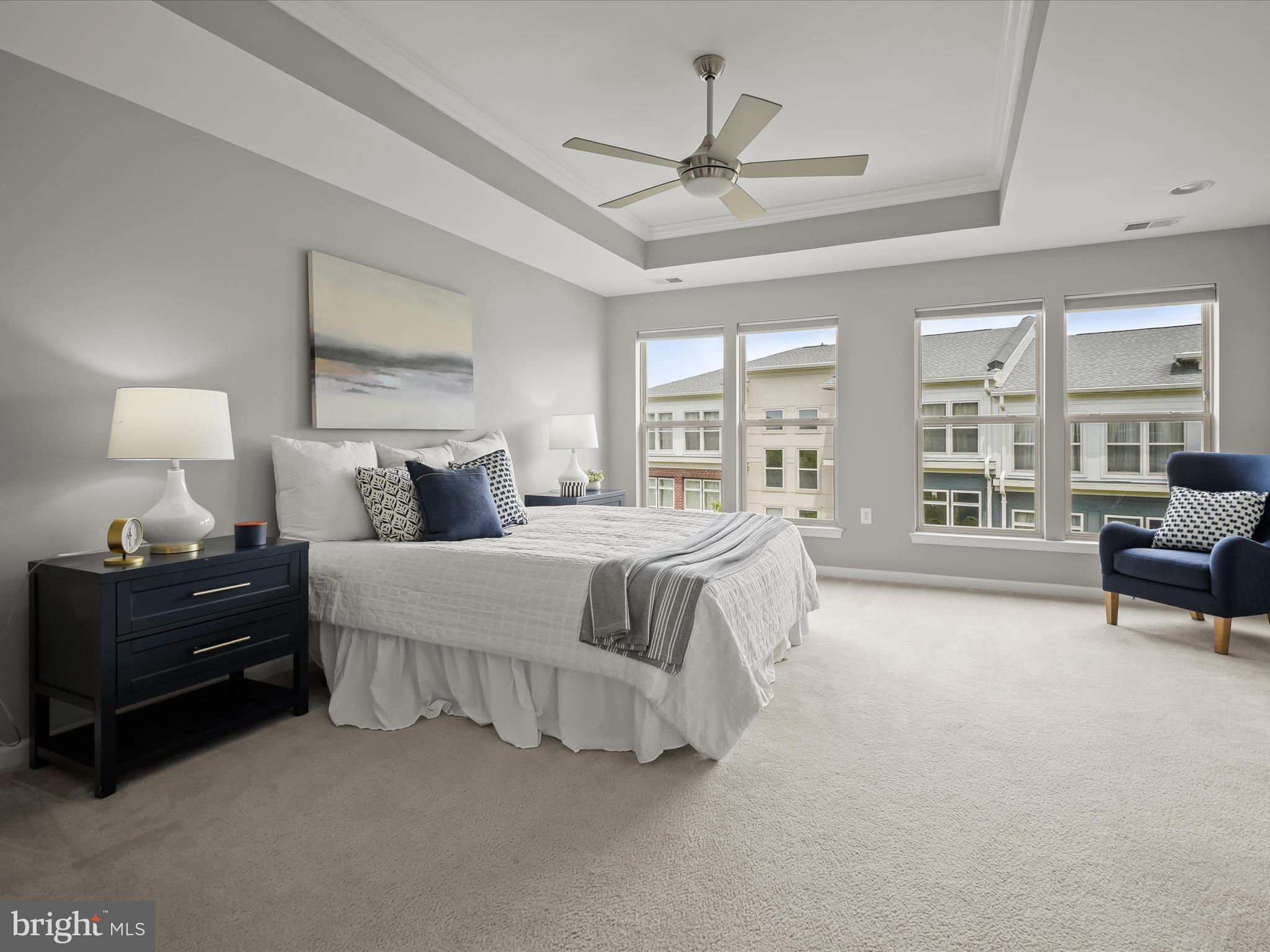 179 Copley Circle, Unit 30B Gaithersburg, MD 20878 - Photo 29 of 41 a spacious bedroom with a bed a couch and a chandelier