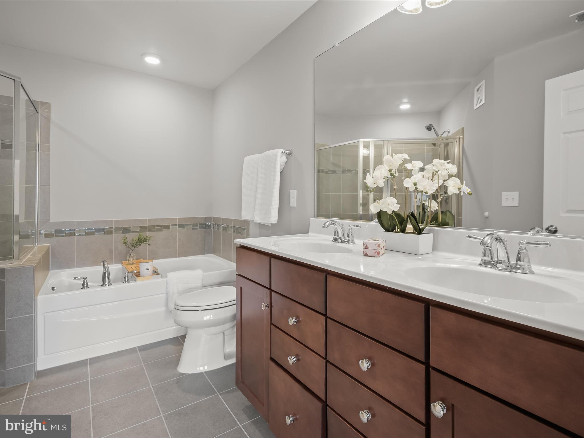 179 Copley Circle, Unit 30B Gaithersburg, MD 20878 - Photo 31 of 41 a bathroom with a double vanity sink mirror and toilet