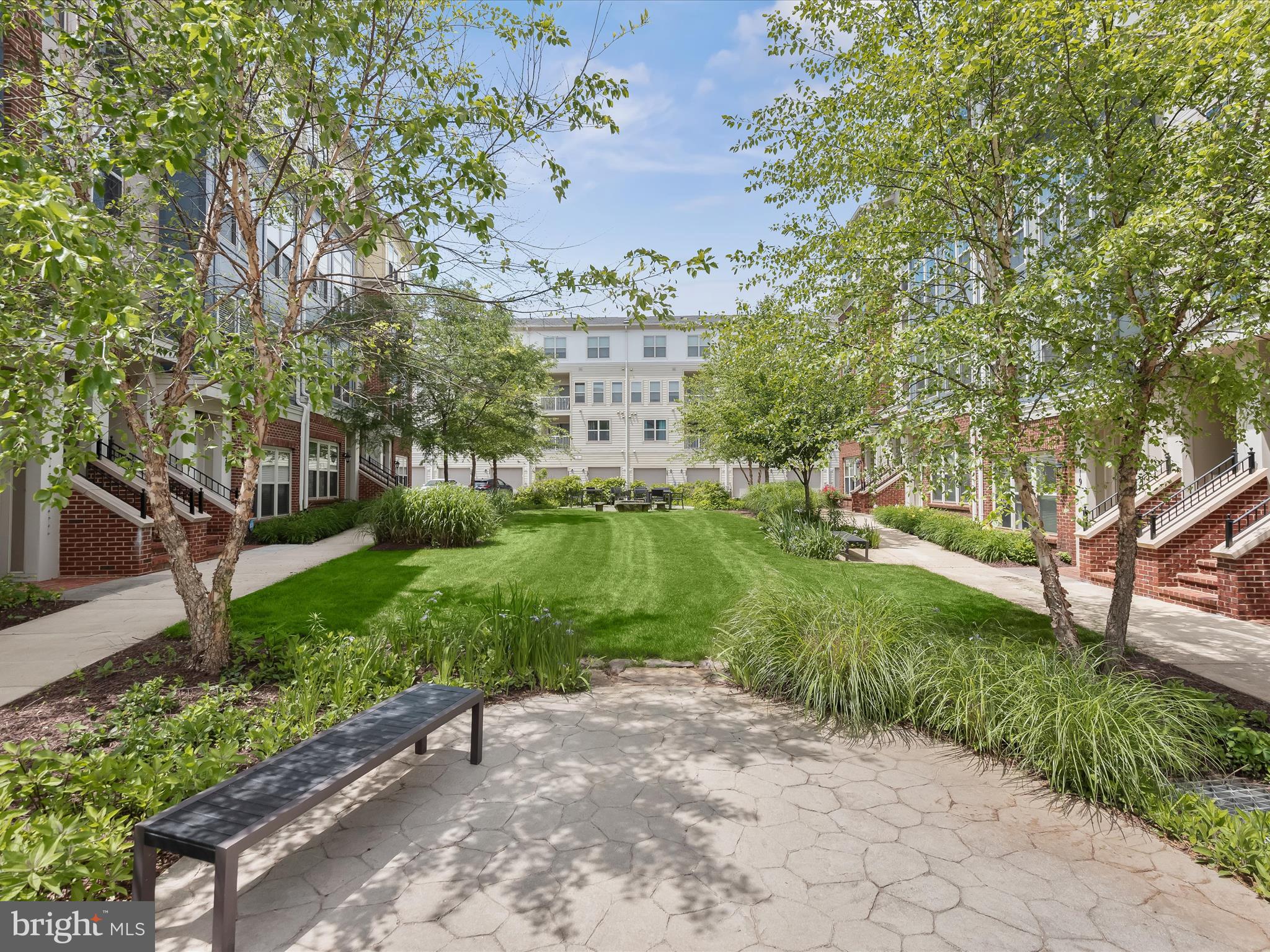 179 Copley Circle, Unit 30B Gaithersburg, MD 20878 - Photo 41 of 41 a view of a garden with a building in the background