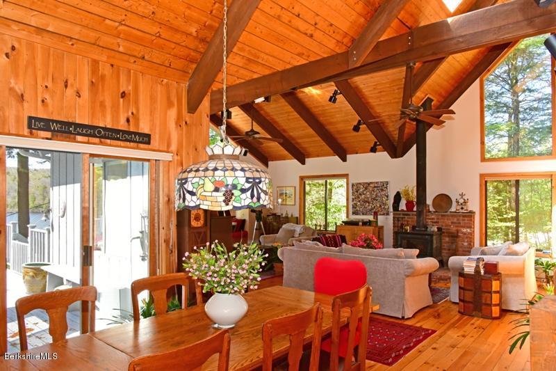 57 Hayes Pond Road Otis, MA 01253 - Photo 20 of 36 a living room filled with furniture and a floor to ceiling window