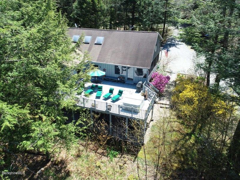57 Hayes Pond Road Otis, MA 01253 - Photo 3 of 36 an aerial view of a house with table and chairs and potted plants
