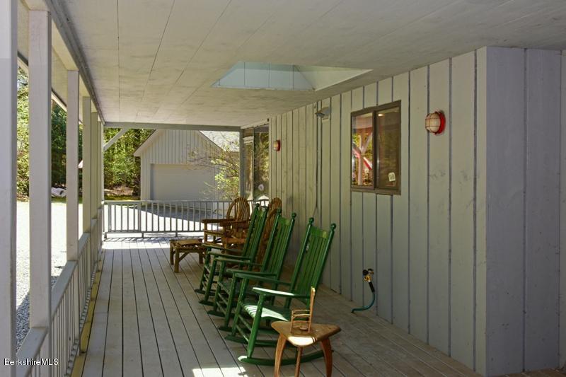 57 Hayes Pond Road Otis, MA 01253 - Photo 7 of 36 a view of a hallway with wooden floor and outdoor seating