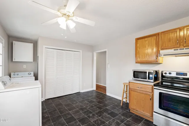a kitchen with a stove a sink and a refrigerator