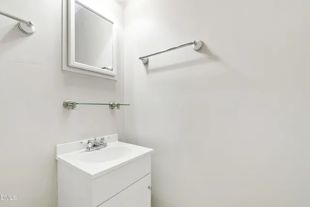 a bathroom with a sink a mirror and shower