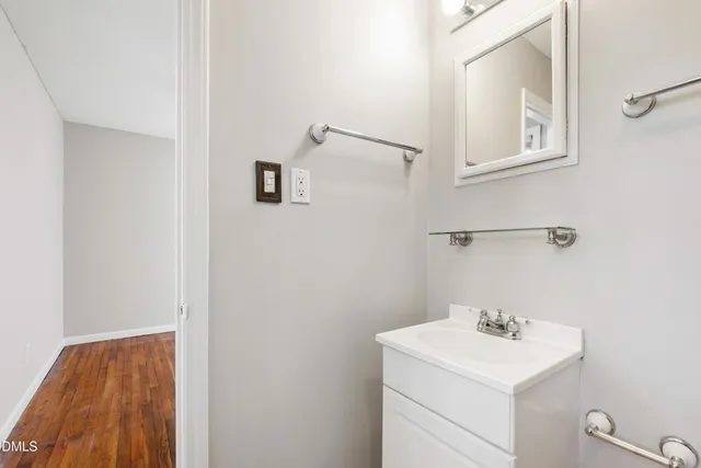 a bathroom with a sink a vanity and mirror