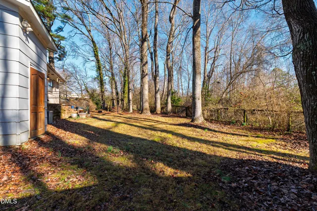 a view of a yard with large trees