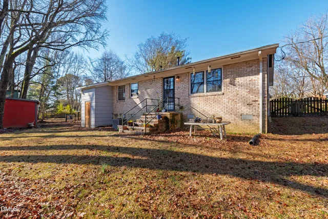 a view of a house with a yard covered in snow