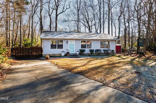 a front view of a building with cars parked