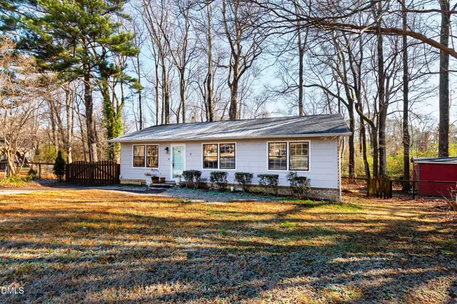 a view of a house with swimming pool and sitting area