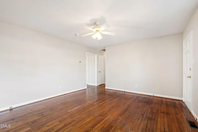 a view of an empty room and wooden floor