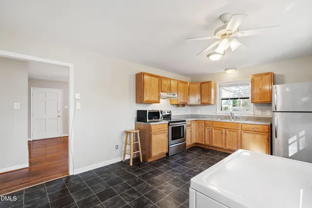a kitchen with a sink appliances and cabinets